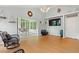 Bright living room with sunroom, hardwood floors, and television above a bench at 3486 Ashwycke St, Mount Pleasant, SC 29466