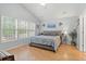 Relaxing main bedroom featuring a queen-sized bed, hardwood floors, and large windows overlooking the yard at 3486 Ashwycke St, Mount Pleasant, SC 29466