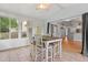 The bright sunroom is surrounded by views of the greenery and has a rustic table at 3486 Ashwycke St, Mount Pleasant, SC 29466