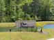 Brick community sign for The Preserve with lush landscaping near a pond and many trees at 3902 Summerton St, Mount Pleasant, SC 29466
