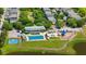 Aerial view of community pool, playground, and basketball court surrounded by lush green spaces and manicured lawns at 417 Verbena Ave, Summerville, SC 29483