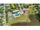 Overhead view shows a pool, basketball court, playground and pond surrounded by green space in a neighborhood at 417 Verbena Ave, Summerville, SC 29483