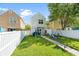 A beautiful backyard with green grass, a white fence and playground equipment at 417 Verbena Ave, Summerville, SC 29483
