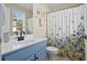 Stylish bathroom featuring a blue vanity, modern black faucet, and floral shower curtain at 417 Verbena Ave, Summerville, SC 29483