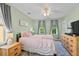 Serene bedroom with lots of natural light features a comfortable bed and stylish wooden dresser at 417 Verbena Ave, Summerville, SC 29483