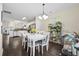 Bright dining room boasts a white table with seating for six, dark floors, and abundant natural light at 417 Verbena Ave, Summerville, SC 29483