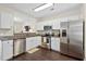 Well-equipped kitchen features stainless steel appliances, granite countertops, and white cabinets for ample storage at 417 Verbena Ave, Summerville, SC 29483