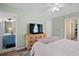 Relaxing main bedroom features an en-suite bathroom and stylish wooden dresser, creating a serene retreat at 417 Verbena Ave, Summerville, SC 29483