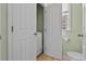 Powder room with toilet and an adjacent door leading to laundry closet with washer and dryer at 417 Verbena Ave, Summerville, SC 29483