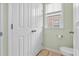 Convenient powder room features a toilet, small window, and crisp white doors for privacy at 417 Verbena Ave, Summerville, SC 29483