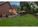 Large backyard featuring a brick patio, white railing staircase, and green lawn at 4209 Wildwood Lndg, Charleston, SC 29420