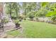 Backyard with green lawn, patio, and mature trees at 4209 Wildwood Lndg, Charleston, SC 29420