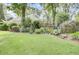 Spacious backyard with lush lawn, garden beds, and mature trees providing shade and privacy at 4209 Wildwood Lndg, Charleston, SC 29420