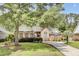 Charming brick home with well-manicured lawn, mature trees, and a long driveway at 4209 Wildwood Lndg, Charleston, SC 29420