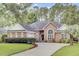 Traditional brick home with well-maintained landscaping and a circular driveway, offering great curb appeal at 4209 Wildwood Lndg, Charleston, SC 29420