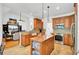 Open-concept kitchen with granite countertops, pendant lighting, and stainless-steel appliances at 4209 Wildwood Lndg, Charleston, SC 29420