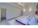 Bright bedroom with floral bedding, tray ceiling with modern light fixture, and ensuite entrance at 4374 Cotton Flat Rd, Summerville, SC 29485