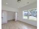Minimalist bedroom with wood-look flooring, large windows, view of neighborhood and pink glass pane doors at 4374 Cotton Flat Rd, Summerville, SC 29485