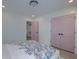 Bright bedroom with floral bedding, pink doors, and walk-in closet at 4374 Cotton Flat Rd, Summerville, SC 29485