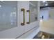 Close-up of kitchen cabinetry featuring glass doors and modern brass pulls at 4374 Cotton Flat Rd, Summerville, SC 29485