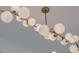 Elegant and contemporary chandelier featuring spherical bulbs and gold fixtures creates a stylish and inviting atmosphere at 4374 Cotton Flat Rd, Summerville, SC 29485