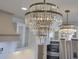 Elegant crystal chandelier lighting illuminating the kitchen at 4374 Cotton Flat Rd, Summerville, SC 29485