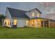 Exterior view of home with a well-maintained lawn and screened in porch, perfect for outdoor enjoyment at 4374 Cotton Flat Rd, Summerville, SC 29485