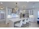 Stylish kitchen boasts white cabinets, a large island, stainless appliances, and elegant crystal chandeliers at 4374 Cotton Flat Rd, Summerville, SC 29485