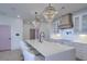 Stunning kitchen with a large island, quartz countertops, white cabinets, and designer pendant lights at 4374 Cotton Flat Rd, Summerville, SC 29485