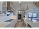Modern kitchen featuring stainless steel appliances, quartz countertops, island, and elegant chandelier lighting at 4374 Cotton Flat Rd, Summerville, SC 29485