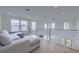 Bright loft area with comfortable seating, wood floors, and large windows offering natural light and scenic views at 4374 Cotton Flat Rd, Summerville, SC 29485