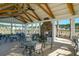 Relax in the covered pavilion with plenty of seating and a cozy outdoor fireplace feature at 4374 Cotton Flat Rd, Summerville, SC 29485