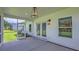 Covered screened porch offering an outdoor living space with a view of the backyard at 4374 Cotton Flat Rd, Summerville, SC 29485