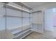 Walk-in closet with custom built in gray shelving for maximum organization at 4374 Cotton Flat Rd, Summerville, SC 29485