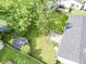 Aerial view of a large backyard with a deck, storage shed, and mature trees at 5 Drummond Ct, Charleston, SC 29414