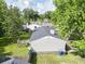 Aerial view of house with a large backyard, trees, fence, and wooden deck at 5 Drummond Ct, Charleston, SC 29414
