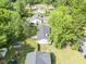 Aerial view of house with large backyard, trees, fence, and small wooden deck at 5 Drummond Ct, Charleston, SC 29414