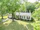 Charming single-story home featuring a well-manicured lawn and beautiful mature trees at 5 Drummond Ct, Charleston, SC 29414