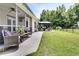 Spacious backyard with a covered patio, outdoor seating, and a gazebo with grill at 5013 Franconia Dr, Summerville, SC 29485