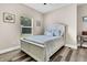 Cozy bedroom features hardwood floors, window views, and a white wooden bed frame at 5013 Franconia Dr, Summerville, SC 29485