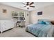 Bright bedroom featuring a ceiling fan, window views, and a well-lit desk space at 5013 Franconia Dr, Summerville, SC 29485