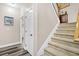 Hallway with gray wood-look flooring leading to carpeted stairs and doors at 5013 Franconia Dr, Summerville, SC 29485