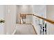 Hallway with wooden railing and stairs leading to the lower level with visible living room furniture at 5013 Franconia Dr, Summerville, SC 29485