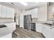 Kitchen with stainless appliances, grey countertops and ample white cabinets at 5013 Franconia Dr, Summerville, SC 29485