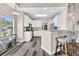 Bright open kitchen with white cabinets, stainless appliances, and bar seating at 5013 Franconia Dr, Summerville, SC 29485