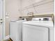 Functional laundry room with modern Samsung washer and dryer, and a wire shelf at 5013 Franconia Dr, Summerville, SC 29485