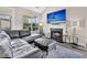 Stylish living room featuring a cozy fireplace, large windows, vaulted ceilings and comfortable leather seating at 5013 Franconia Dr, Summerville, SC 29485