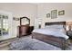 Bedroom featuring tray ceilings, wood flooring, an ensuite bathroom, and an exterior door at 5013 Franconia Dr, Summerville, SC 29485