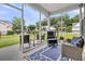 Inviting screened-in porch with comfortable seating, a blue rug, and views of the front yard at 5013 Franconia Dr, Summerville, SC 29485