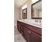Bathroom featuring double sinks, dark wood cabinets, and modern fixtures at 5540 Indigo Fields Blvd, North Charleston, SC 29418